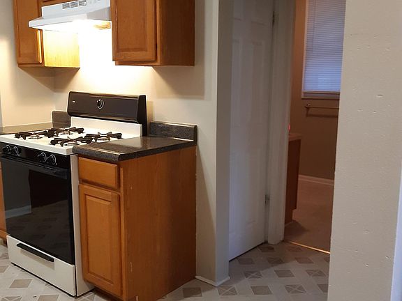 Kitchen, basement door and entry to bathroom
