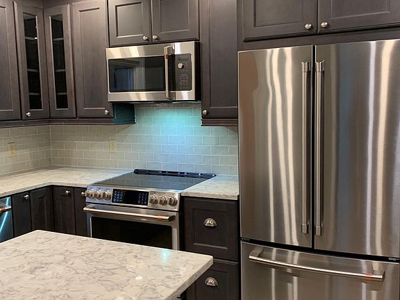 Kitchen -new range, refrigerator and microwave