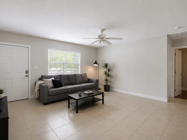 The living room boasts an open-concept design with luxury vinyl plank flooring, plenty of natural light, and seamless flow into the kitchen and dining areas. *Furniture not included*