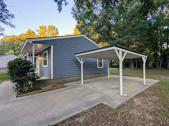 Large driveway with covered parking.