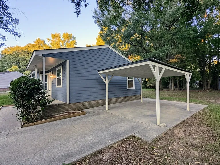 Large driveway with covered parking.