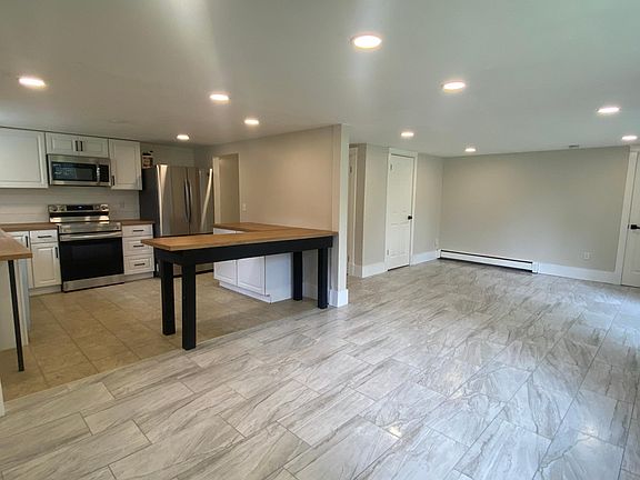 Dining area looking into living room and kitchen