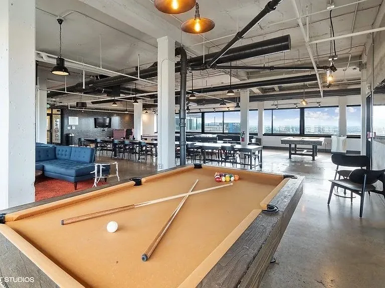 Penthouse entertainment lounge with pool tables at Archer Tower in Denver, CO