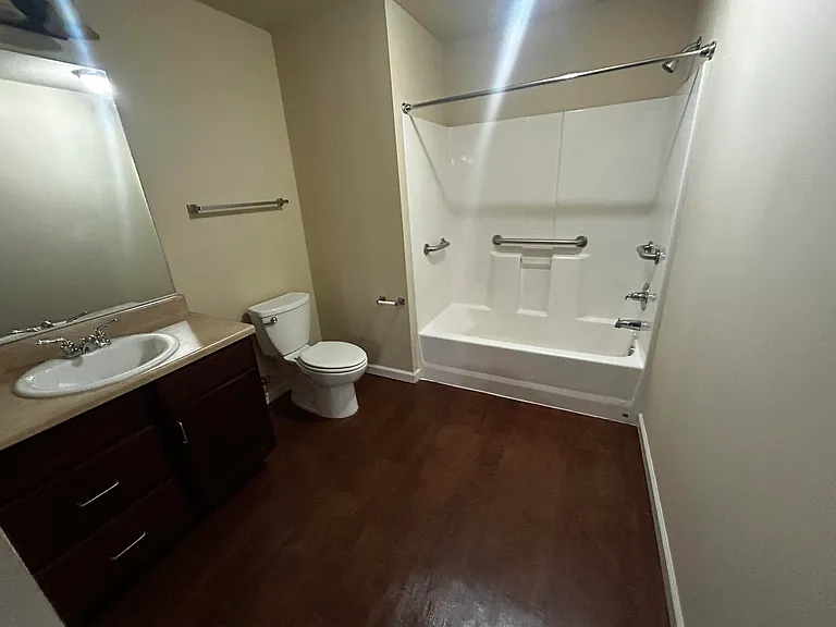 Bathroom with tub and grab bars for safety