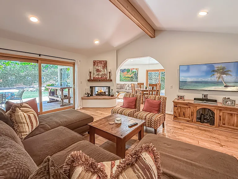 Living room with fireplace opens to family room and kitchen