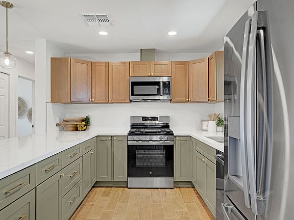 Enjoy a modern kitchen with sleek countertops, stainless steel appliances, and plenty of cabinetry for all your cooking needs.