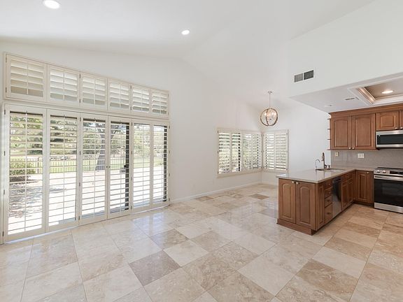 Kitchen & breakfast/informal dining area with sliding doors leading to backyard with incredible view of the golf course