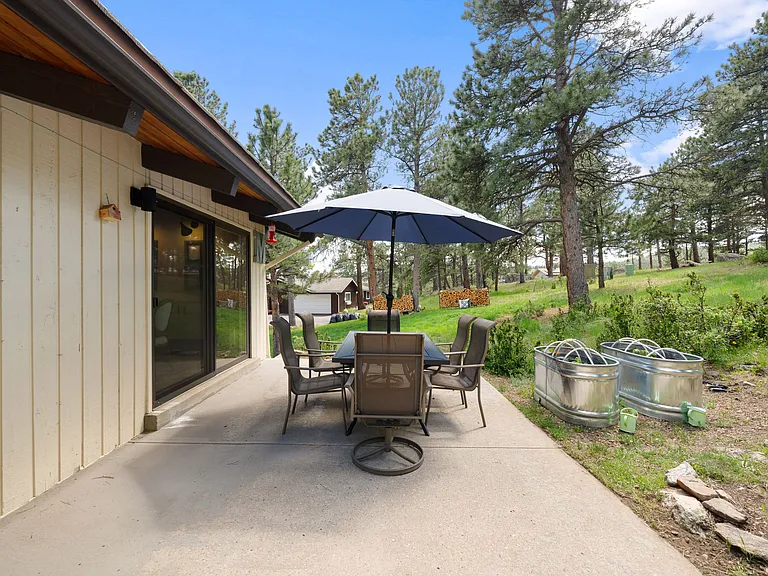 Outdoor seating area, and room for garden behind 1 of 3 sliding glass doors.