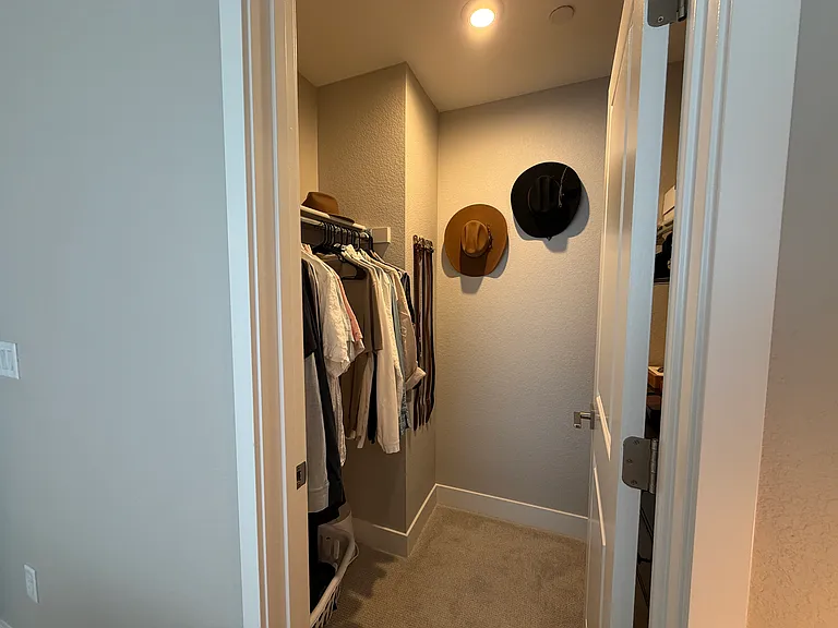 Main bedroom walk-in closet with built-in shelving