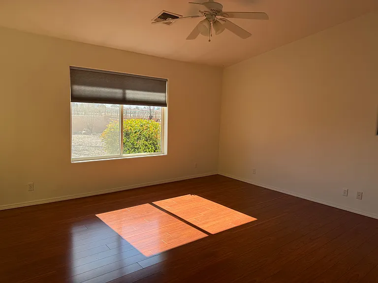 Master bedroom looking into backyard with sliding glass door