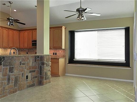 Dining/breakfast area next to the kitchen features a window seat.