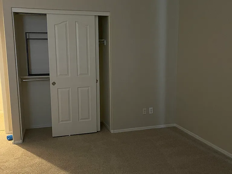 Primary bedroom with sliding door to the patio to the right.