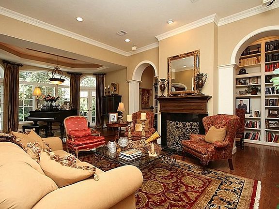  Enchant your guests in this fabulous living room featuring hardwood floors, crown moldings, and a gas fireplace