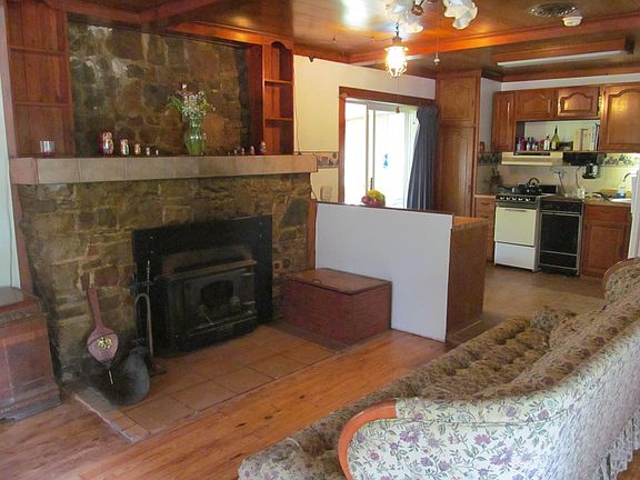 Kitchen with doors to sunroom, living room fireplace