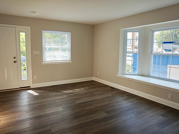 Front entrance to large open family room with bay window for plenty of natural light and recessed lighting throughout house.