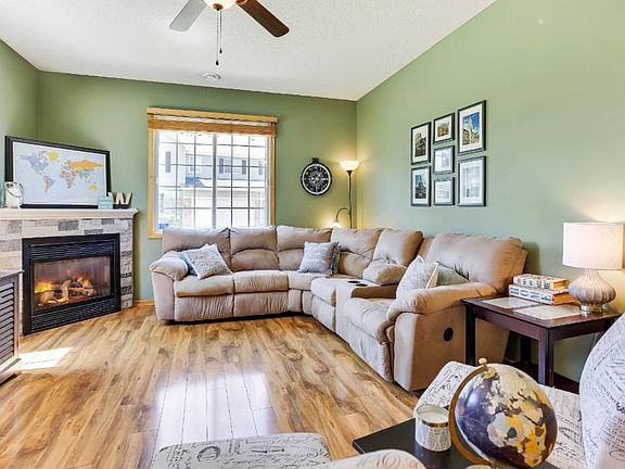 Large living room with gas fireplace and laminate floors throughout the living room and dining room.