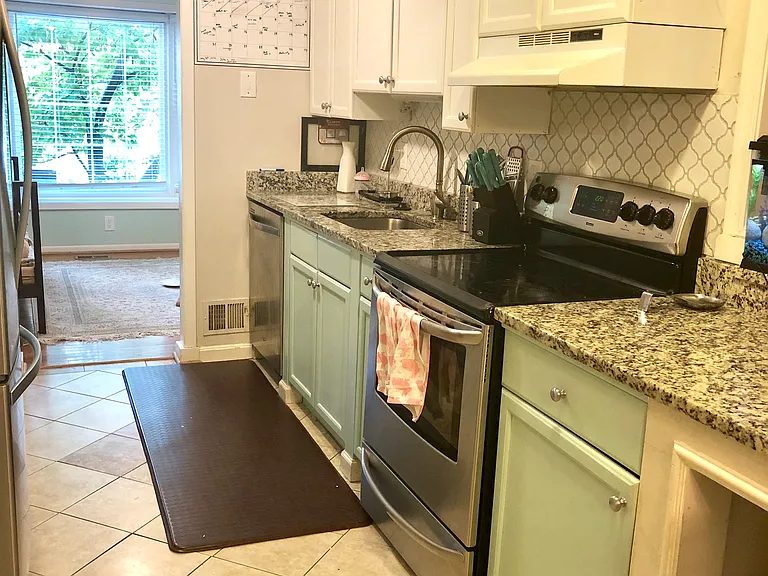 Galley kitchen opens to both sitting areas