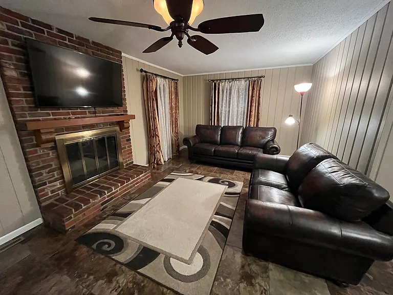 Matching Leather Lazy-Boy Sofa and Loveseat. nice carpet over beautiful shiny tile. Very nice, natural gas assisted fireplace with Like New 55" Samsung TV. Remote control fan/light.