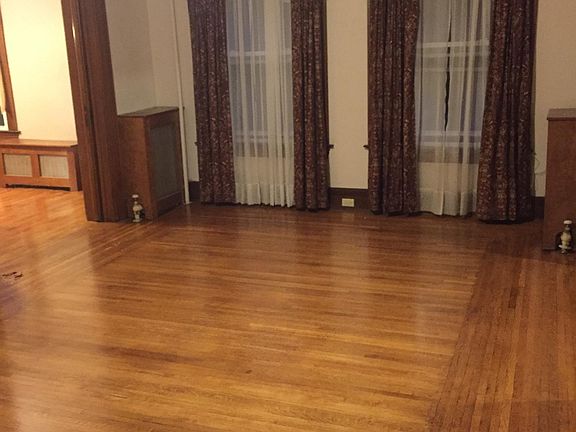 Large family room with big windows, and beautiful hardwood floors. Front living room adjoins to the right.