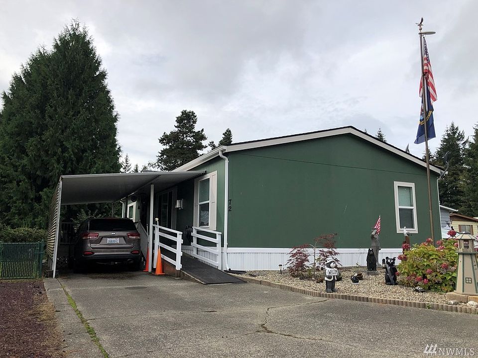 Double car driveway with carport and accessibility ramp.