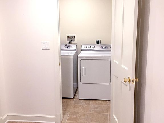 In unit private laundry room with full size washer & dryer.