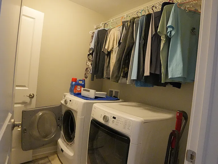 2 closets in laundry room, with shelves