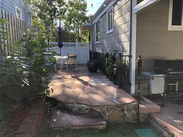 Side flagstone patio and BBQ gas grill