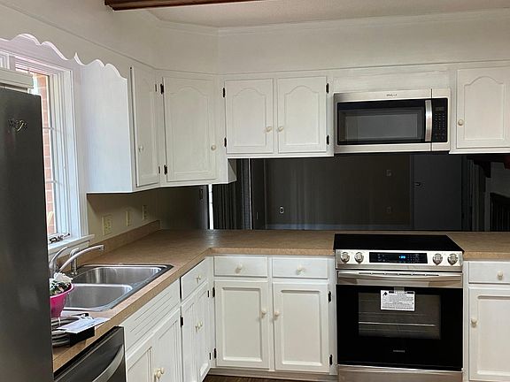 Kitchen with new stainless steel appliances.