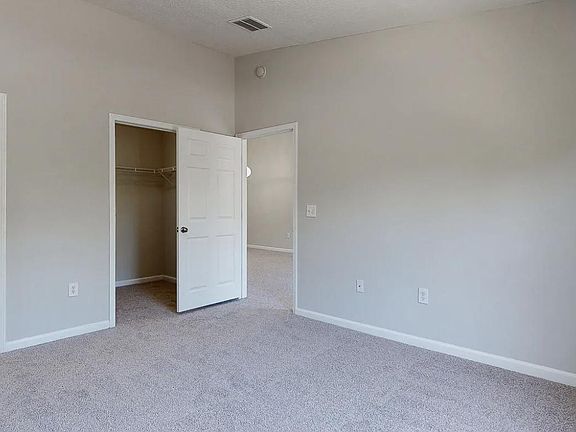 Primary suite showing bathroom and walk-in closet