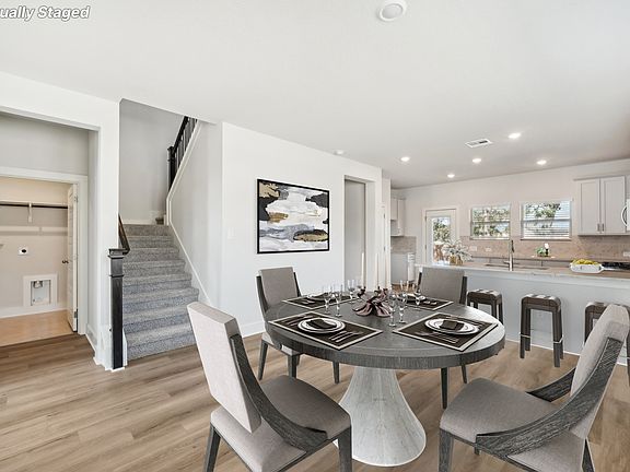 Virtually staged dining room and kitchen in the Medina floorplan at a Meritage Homes community.