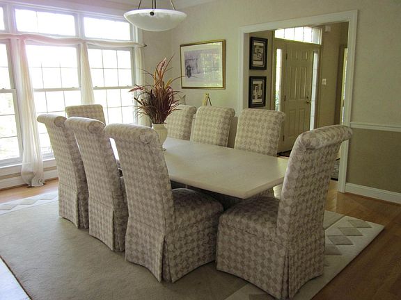 DR with wide crown molding, chair rail and custom windows