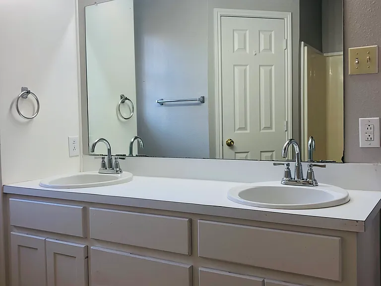 Master has double sinks, bath and shower combo.