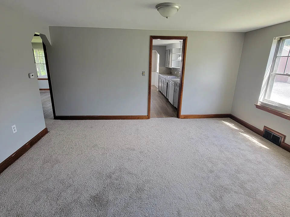Dining room with new carpet and plenty of natural light.