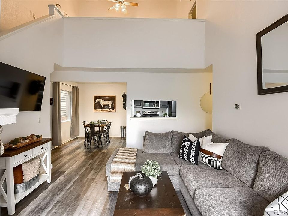 Front room with wood burning fireplace & loft above.
