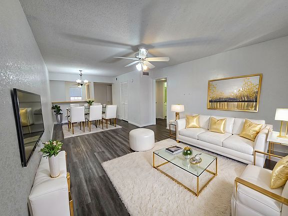 LIVING ROOM WITH VIEW OF KITCHEN AND HALLWAY TO PRIMARY BEDROOM - VIRTUALLY STAGED