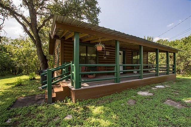 14303 Cochise Trail is a log cabin being sold with two lots.