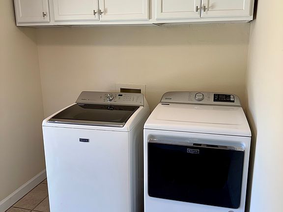 Separate Laundry Room with storage cabinets. Washer and Dryer INCLUDED