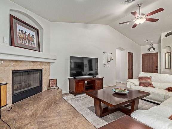 Great room with vaulted ceiling and fans