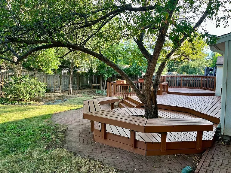 large back yard with mature trees