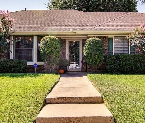 Wide steps up to house builds interest in front yard