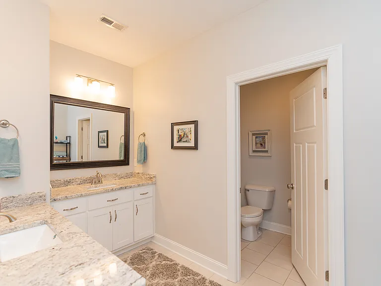 Large Full Bathroom with 2 vanities and separate room with tub/shower and toilet