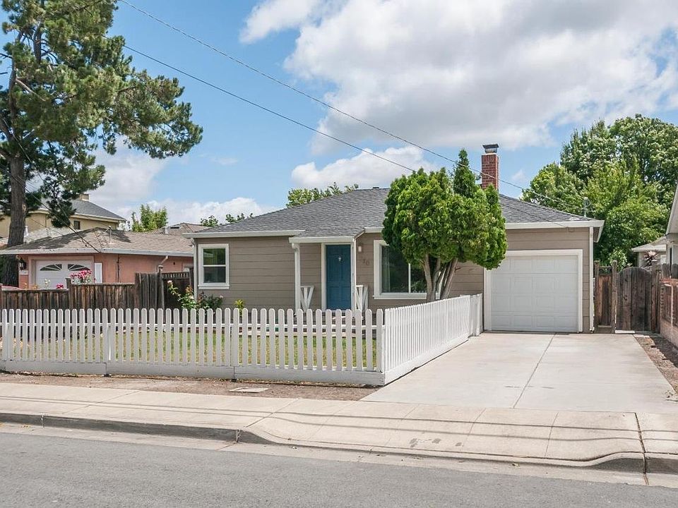 Front with 1 car garage, and long driveway that fits 2 cars in tandem
