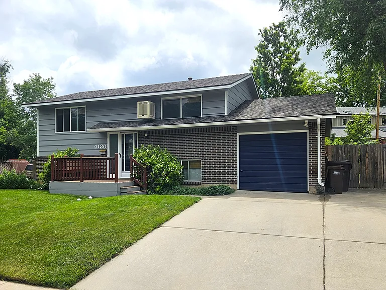 Front of house, one car garage and two parking spaces in driveway