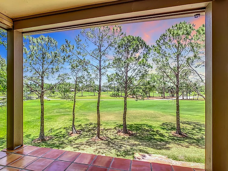 West-facing screened-in balcony where you can enjoy beautiful sunsets over the golf course. (Note that the balcony was undergoing maintenance at time of photo and the photo does not show the railing or screen)