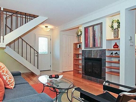 Living room has gas fireplace with 47' TV mounted above