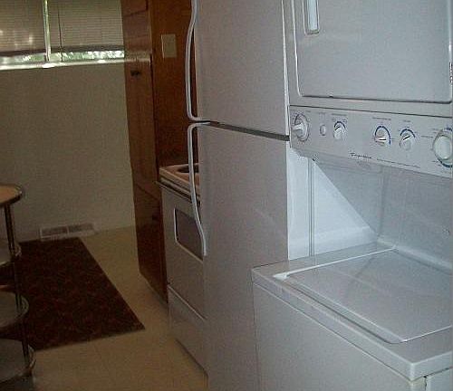 Kitchen with Range, Refrigerator & Stackable Washer & Dryer