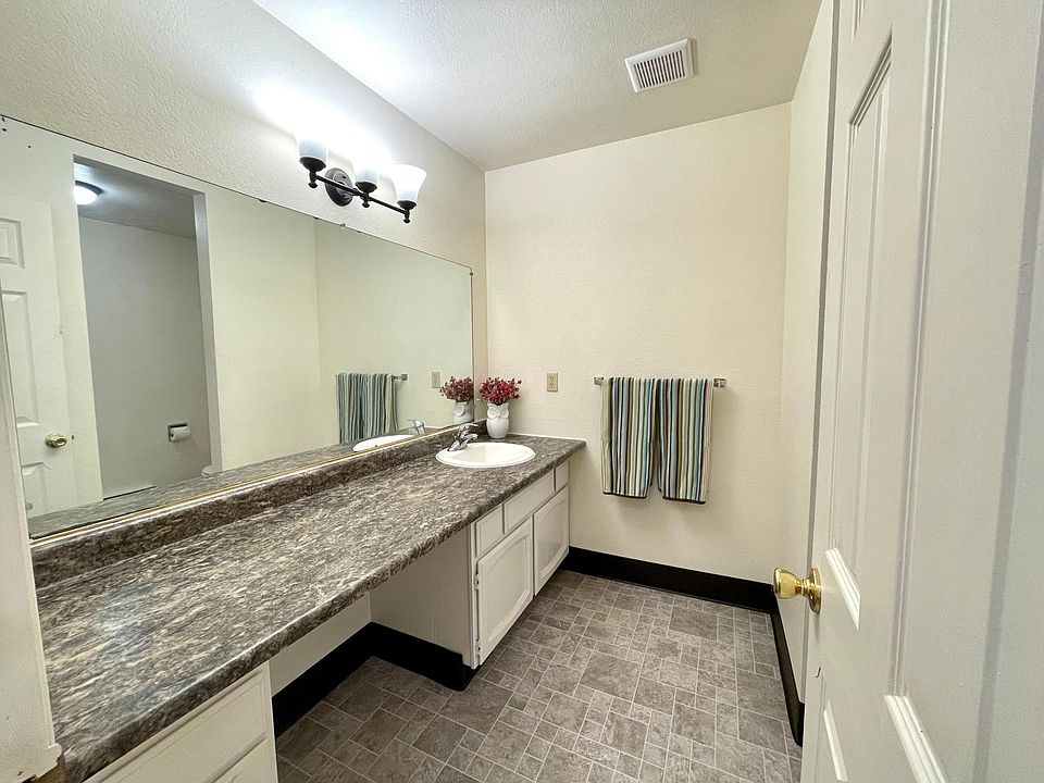 Huge bathroom with large vanity.