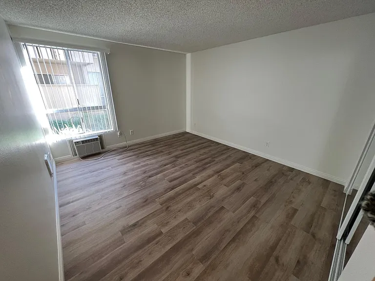 Primary upstairs bedroom looking toward air conditioner and window. 2x2
