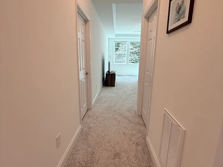 primary suite wing with walk-in his/her closets on each side
