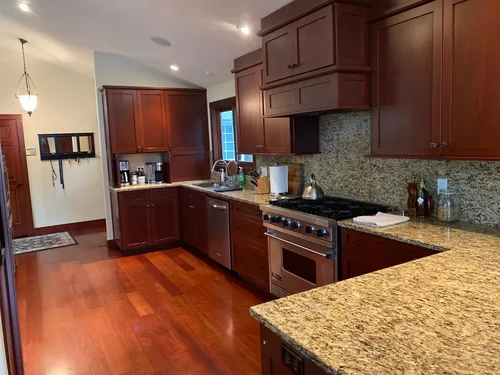 Slab granite counters and backsplash. Huge kitchen with built-ins and pullout drawers. Custom cherry cabinets. - Cardinal Dr